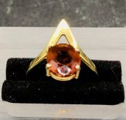 An 18 ct gold ring with central amber coloured stone