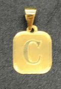 An 18 ct yellow gold C pendant