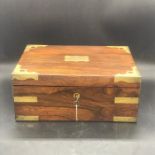 A Brass Banded Mahogany travel box with removable compartments, original bottles and ivory pots,
