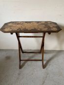 Campaign style table with carved fruit decoration to top (H74cm W80cm D36cm)