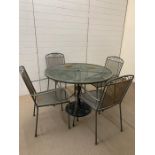 Metal garden table and chairs with cast iron umbrella stand