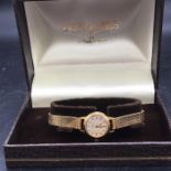 An 18 ct gold Ladies wristwatch, Optimatic 21 jewels