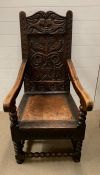 A Wainscot carved oak chair with arm supports and bobbin stretchers