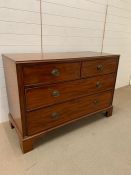 A two over two chest of drawers with brass drop handles (H93cm D57cm W136cm)