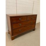 A two over two chest of drawers with brass drop handles (H93cm D57cm W136cm)