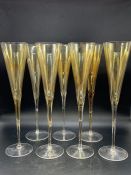 Seven amber champagne flutes