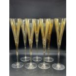 Seven amber champagne flutes