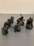 Six small carved elephants approx H9cm