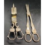 Two silver plated items, a candle wick trimmer/snuffer and a pair of grape scissors