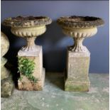 A pair of reclaimed stone urn planters on square plinth (H82cm Dia49cm Base 28cm)
