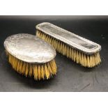 Two Hallmarked silver backed dressing table brushes and two silver topped dressing table bottles.