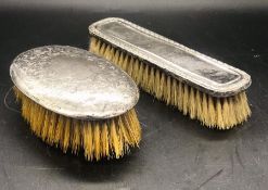 Two Hallmarked silver backed dressing table brushes and two silver topped dressing table bottles.