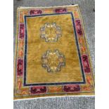 A Chinese rug, with mustard grounds and dragon theme. (200cm x 153cm)