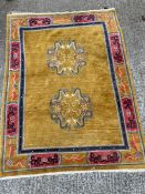 A Chinese rug, with mustard grounds and dragon theme. (200cm x 153cm)