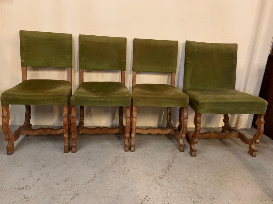 Set of four dining chairs with green upholstered backs and seat