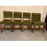 Set of four dining chairs with green upholstered backs and seat