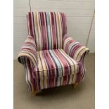A Lounge armchair with striped upholstery