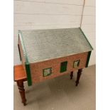 Tri-ang dolls house in the style of a bungalow 1950/60s. L70cm H42cm W50cm
