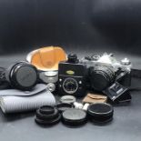 A Case of Camera Equipment to include a Canon AE-! camera with two lenses and assorted equipment