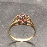 A 9 ct yellow gold and garnet ring (1.8g)
