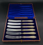 Three boxes of silver handled knives