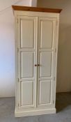 A large solid cream painted pine wardrobe with hanging rail and shelves (H230cm W91cm D58cm)