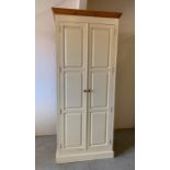 A large solid cream painted pine wardrobe with hanging rail and shelves (H230cm W91cm D58cm)