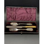 A boxed christening cutlery set, white metal and bone handle