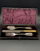 A boxed christening cutlery set, white metal and bone handle