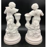 A Pair of Franklin Mint Cherub candlesticks