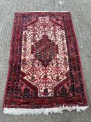 A Red Grounds rug, hand knotted, 170 x 109.