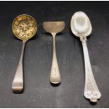 Three assorted silver items, spoon, sugar sifter and a child's food pusher.