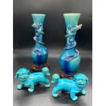 An Oriental pair of Dragon themed vases on stands along with a pair of Foo Dogs.