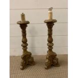A pair of gilt and plaster candle sticks 46cm H