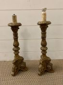 A pair of gilt and plaster candle sticks 46cm H