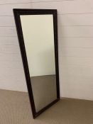 A carved mahogany rectangular mirror (H130cm W50cm)