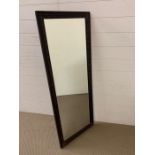 A carved mahogany rectangular mirror (H130cm W50cm)