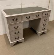 Painted pedestal desk with green leather top and brass drop handles