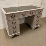 Painted pedestal desk with green leather top and brass drop handles