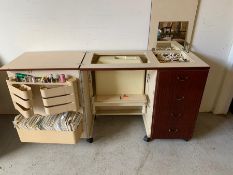 A sewing table complete with a Bernina Matic 910 Electronic sewing machine and sewing patterns.