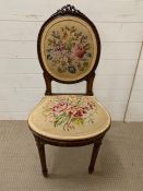 A mahogany bedroom chair with embroidered upholstery