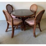 A cane and wicker dining table and four chairs (dia 106cm)