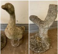 A garden stone tree stump ornament and stone duck ornament