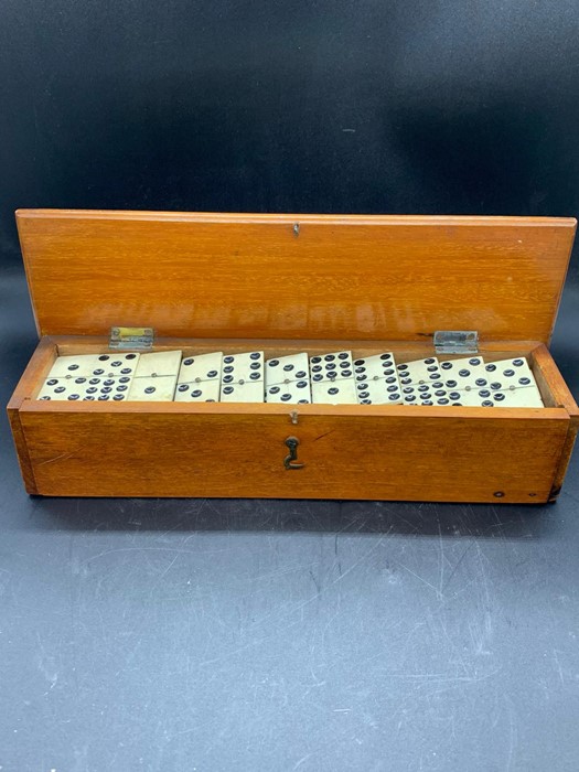 A set of Antique ivory and ebony-backed dominoes