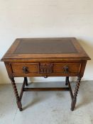 A low boy style desk with leather top and barley twist legs, drawer to centre with compartments (