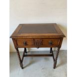 A low boy style desk with leather top and barley twist legs, drawer to centre with compartments (