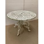 A wrought iron garden table (H67cm W90cm)