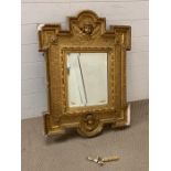 Carved and giltwood wall mirror, in the manner of William Kent. The frame centered with a cherub
