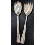 A pair of hallmarked salad servers, in an Art Deco style, makers mark CW, Sheffield 1967