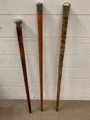 A set of three silver topped walking canes.